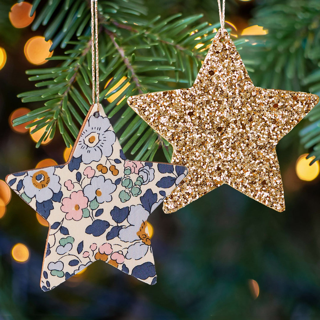 a close up of two ornaments hanging from a christmas tree